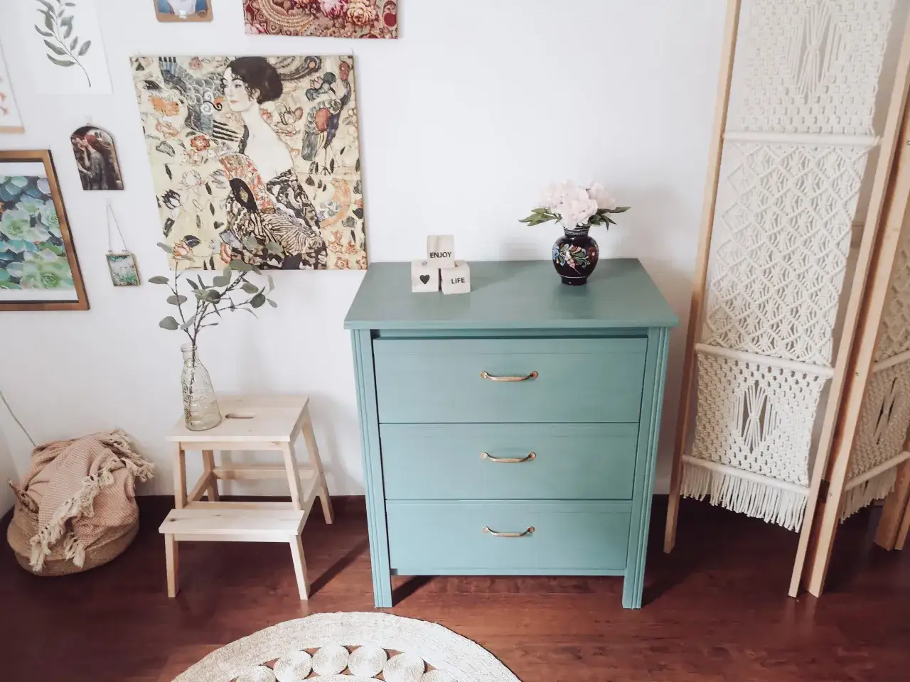 Odnowiona komoda z IKEA w miętowym kolorze, ozdobiona grafikami i kwiatami.